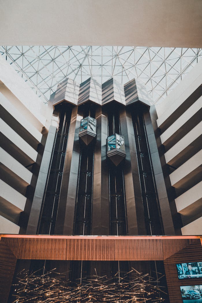 Stunning modern architecture featuring a glass roof and sleek elevators.
