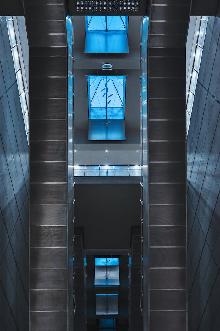 Vertical view of a sleek modern interior with skylight featuring blue glass panels, in Copenhagen.